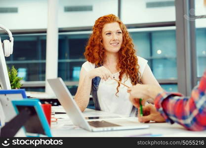 Creative business woman in office. Young and pretty business woman working in office