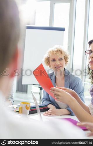 Creative businesswoman in meeting with colleagues at office