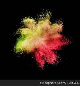 Creative chaotic powder explosion or splash in yellow and red colors on a black background with copy space.. Chaotic burst in yellow red colors on a black background.