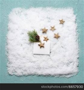 Creative Christmas composition with open envelope with golden stars and fir branch in snow on blue background, top view, flat lay. Winter and holiday concept