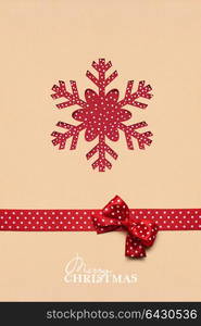 Creative christmas concept photo of a snowflake made of paper on brown background.