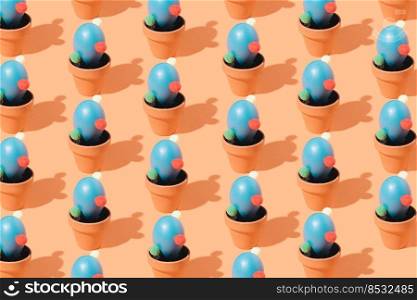 Creative colorful pattern of blue cactus shaped eggs in a flower pots on a brown background. Isometric layout. Easter wallpaper.. Creative colorful pattern of blue cactus shaped eggs in a flower pots on a brown background