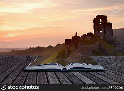 Creative concept image of romantic fairytale castle ruins coming out of pages in magical book