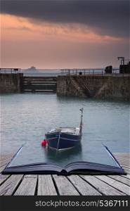 Creative concept pages of book A traditional Cornish fishing village before sunrise in Cornwall England. A traditional Cornish fishing village before sunrise in Cornwall England