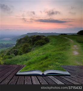 Creative concept pages of book Beautiful vibrant sunrise over rolling countryside landscape