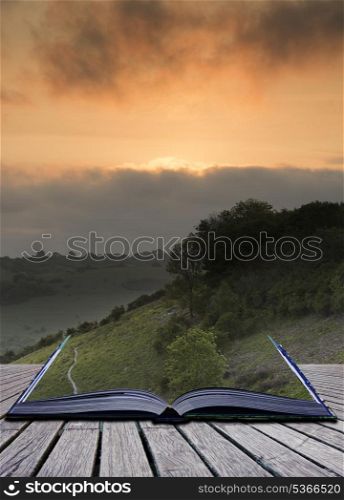 Creative concept pages of book Beautiful vibrant sunrise over rolling countryside landscape