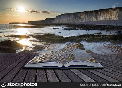 Creative concept pages of book Landscape image of rocky beach at susnet with long exposure motion blur sea. Long exposure landscape rocky shoreline at sunset