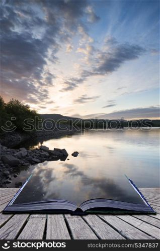 Creative concept pages of book Stunning dramatic sunrise over calm lake