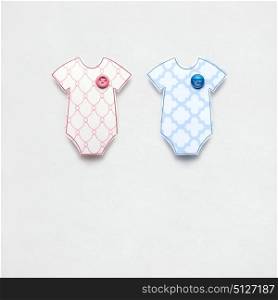 Creative concept photo of a childs jumpers made of paper on grey background.