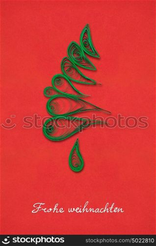 Creative concept photo of a christmas tree made of paper on red background. Frohe Weihnachten.