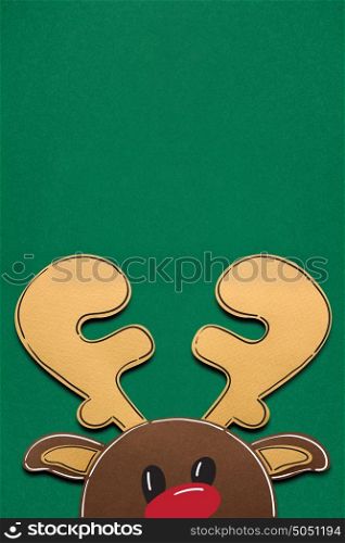 Creative concept photo of a deer made of paper on green background.