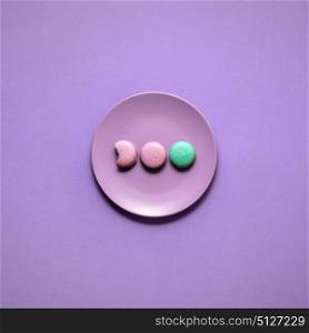 Creative concept photo of a painted plate on purple background.