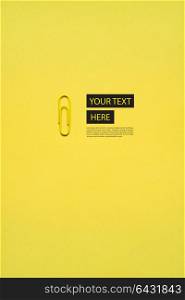 Creative concept photo of a paper clip on yellow background.