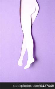 Creative concept photo of body made of paper on purple background.