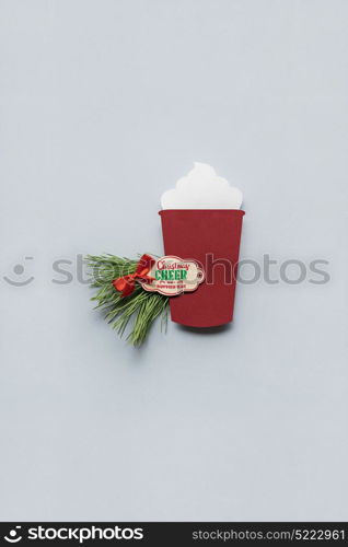 Creative concept photo of christmas coffee take away cup made of paper on grey background.