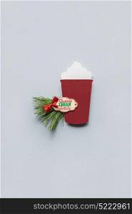 Creative concept photo of christmas coffee take away cup made of paper on grey background.