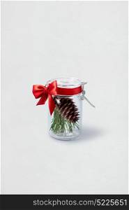 Creative concept photo of christmas decorations in the bottle on white background.