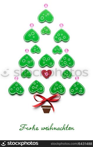 Creative concept photo of christmas tree with heart made of paper on white background. Frohe Weihnachten.