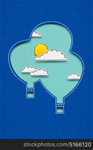Creative concept photo of clouds sun and aerostats made of paper on blue background.