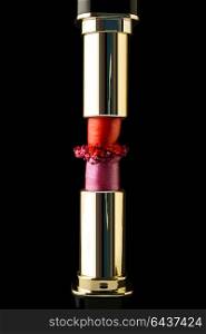 Creative concept photo of cosmetics lipsticks on black background.