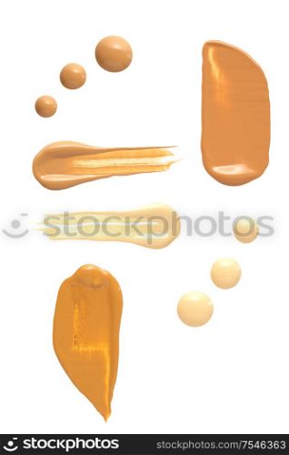 Creative concept photo of cosmetics swatches beauty products foundation cream on white background.