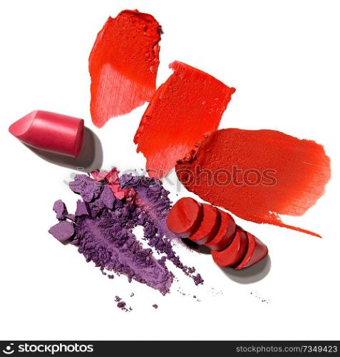 Creative concept photo of cosmetics swatches beauty products lipstick and eyeshadow on white background.