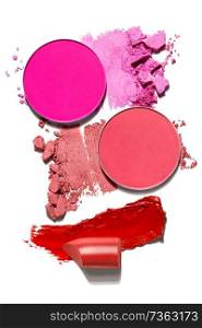 Creative concept photo of cosmetics swatches beauty products lipstick round eyeshadow on white background.