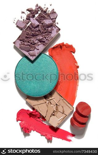 Creative concept photo of cosmetics swatches beauty products lipstick square and round eyeshadow on white background.