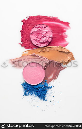 Creative concept photo of cosmetics swatches on white background.