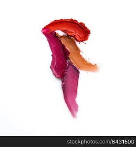 Creative concept photo of cosmetics swatches on white background.