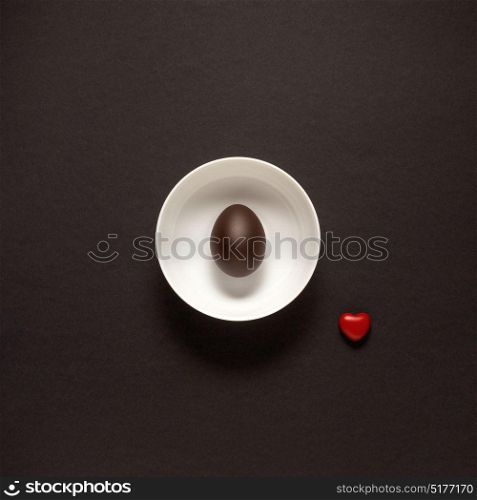 Creative concept photo of kitchenware, painted plate with food on it on black background.