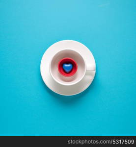 Creative concept photo of kitchenware, painted plate with food on it on blue background.