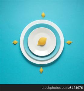 Creative concept photo of kitchenware, painted plate with food on it on blue background.