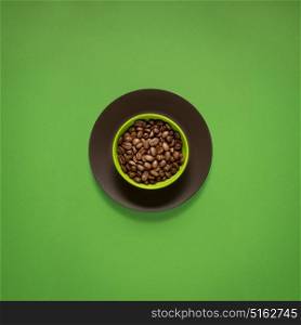 Creative concept photo of kitchenware, painted plate with food on it on green background.
