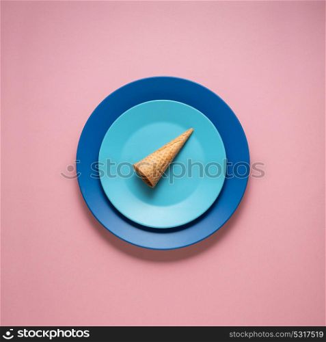 Creative concept photo of kitchenware, painted plate with food on it on pink background.