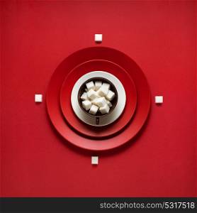 Creative concept photo of kitchenware, painted plate with food on it on red background.