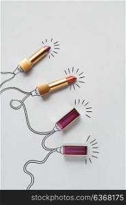 Creative concept photo of lipstick as christmas lights on grey background.