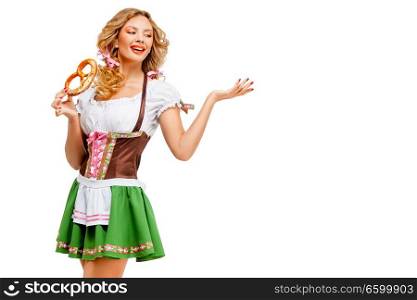 Creative concept photo of Oktoberfest waitress wearing a traditional Bavarian costume with pretzels isolated on white background.