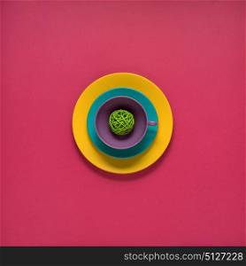 Creative concept photo of painted plates on pink background.