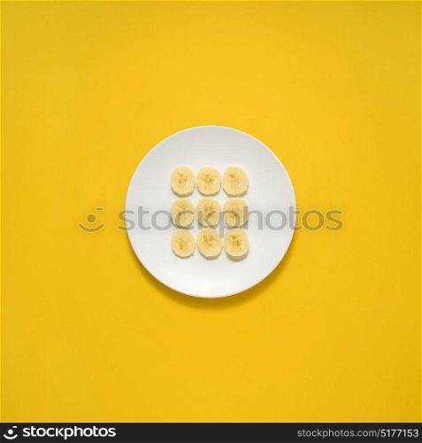 Creative concept photo of painted plates on yellow background.