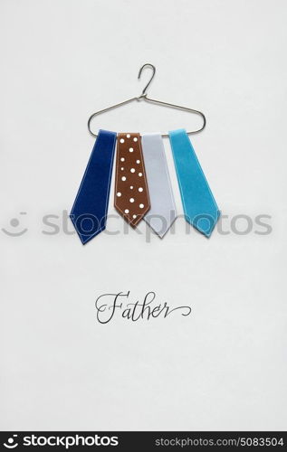 Creative concept photo of ties on a hanger made of paper on white background.