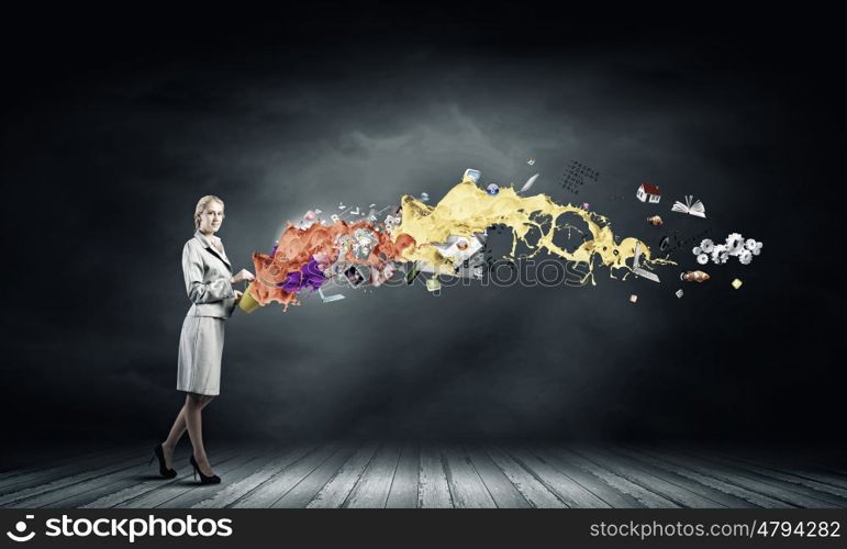 Creative concept. Young businesswoman holding bucket with paint splashes