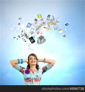 Creative concept. Young woman closing ears with hands and icons flying above