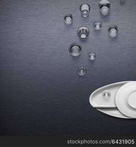 Creative dishware concept; figure of a fish blowing bubbles made of plates and glasses.