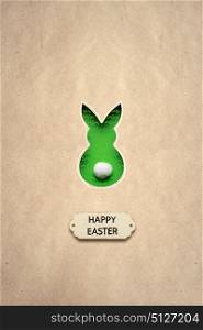 Creative easter concept photo of a rabbit made of paper on brown background.