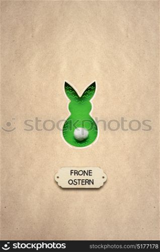 Creative easter concept photo of a rabbit made of paper on brown background. Frone Ostern.