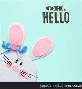 Creative easter concept photo of a rabbit made of paper on mint background.