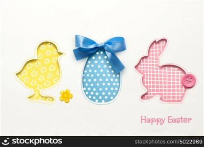 Creative easter concept photo of chicken egg and rabbit made of paper on white background.