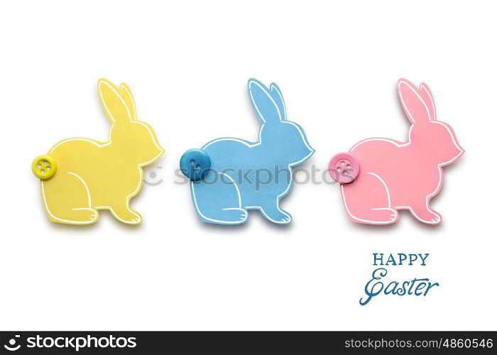 Creative easter concept photo of three rabbits made of paper on white background.