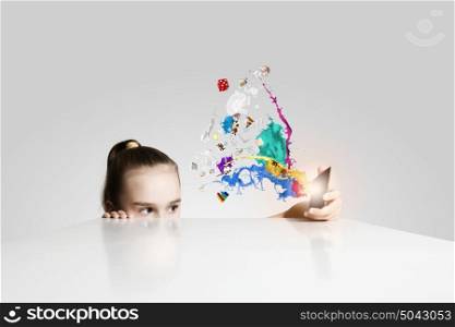 Creative education. Little cute girl and colorful paint splashes
